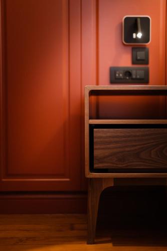 a tv sitting on top of a wooden table at The Bold Type Hotel, a Member of Design Hotels in Patra