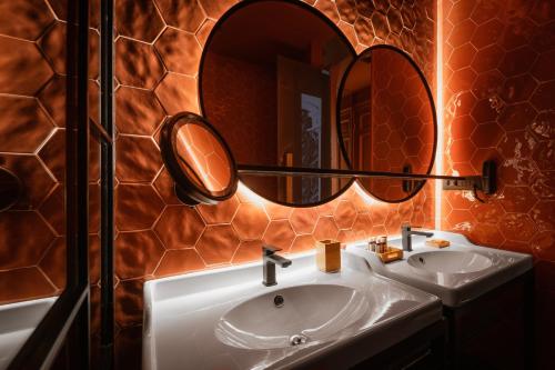 a bathroom with a sink and a mirror at The Bold Type Hotel, a Member of Design Hotels in Patra