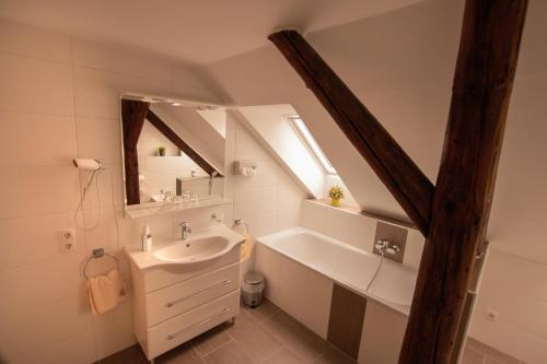 a bathroom with a sink and a mirror at Gästehaus Waldeslust in Espenau