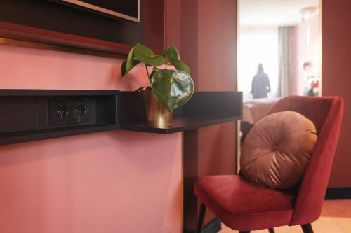 a plant in a vase on a shelf in a room at Holiday Inn - the niu, Loco Munich North by IHG in Munich
