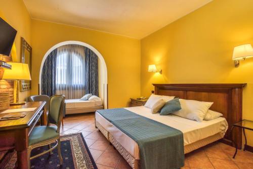 a hotel room with a bed and a desk at Hotel San Giorgio in Campobasso