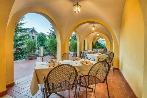 a restaurant with tables and chairs on a patio at Hotel San Giorgio in Campobasso