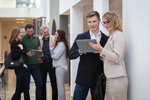 a group of people standing in a building looking at a tablet at Seehof Innsbruck in Innsbruck