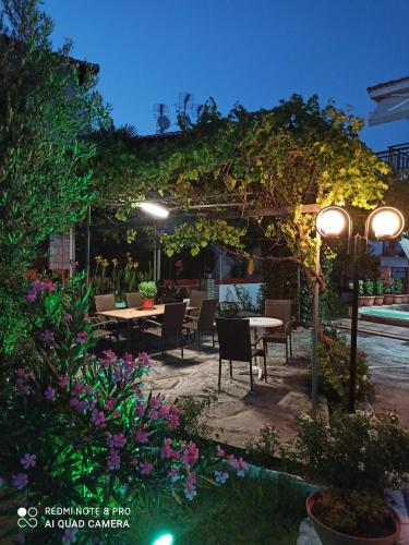 a patio with a table and chairs under a pergola at Studio Nastasia in Afitos