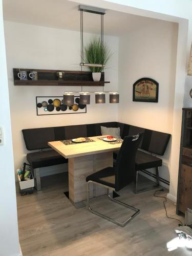 a dining room with a table and black chairs at Haus Kretschmar in Böhl