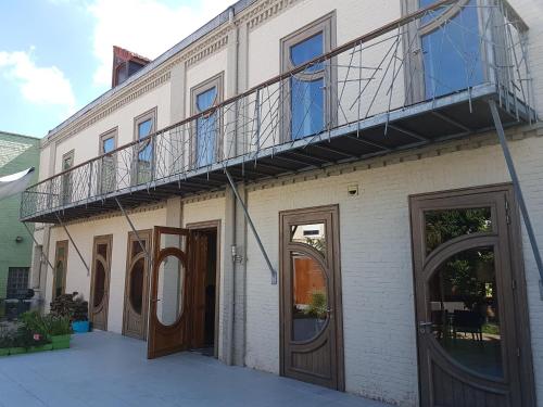 - un balcon sur le côté d'un bâtiment avec des portes en bois dans l'établissement spacieuse maison urbaine proche du centre ville, à Béthune