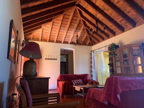 un soggiorno con soffitto in legno e divano. di Villas Las Cercas a El Paso