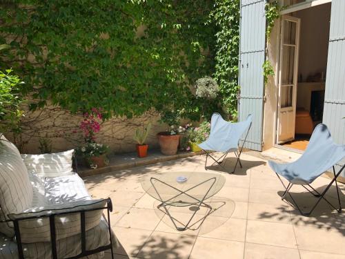 - une terrasse avec 2 chaises et une table dans l'établissement B&B Villa de Margot, à Avignon