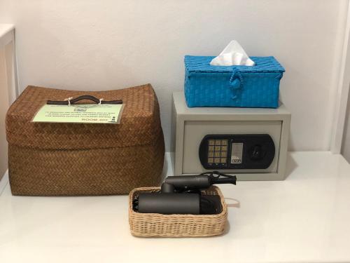 a telephone next to a basket and a box at Bed By Boat @Nonthaburi Pier in Nonthaburi