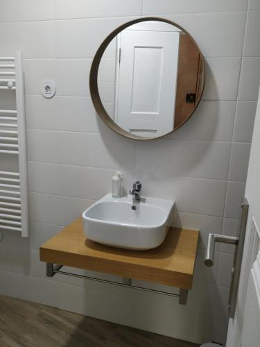 bagno con lavandino e specchio di EntreSocalcos a Loriga