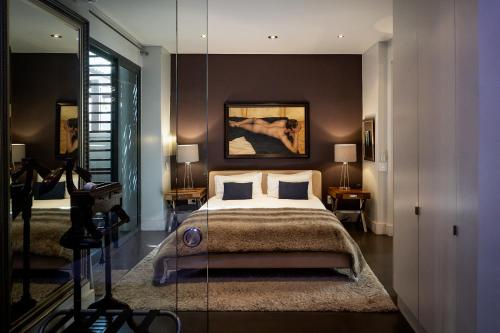 a large bedroom with a bed and a camera at Purple House Accommodations in Cape Town