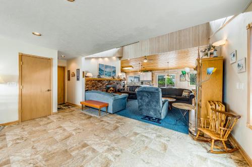 a living room with a couch and a table at Beachtown Bliss in Rockaway Beach