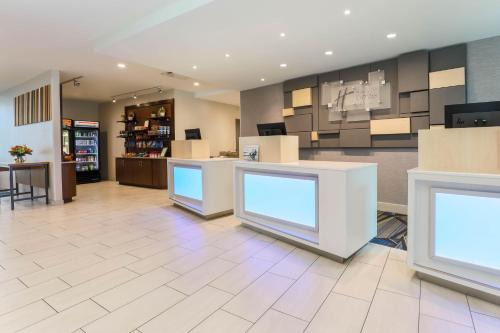 a lobby of a store with blue signs on the counters at Holiday Inn Express & Suites Fort Worth Downtown by IHG in Fort Worth