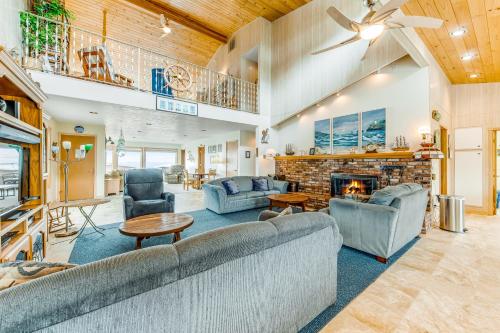 a living room with couches and a fireplace at Beachtown Bliss in Rockaway Beach