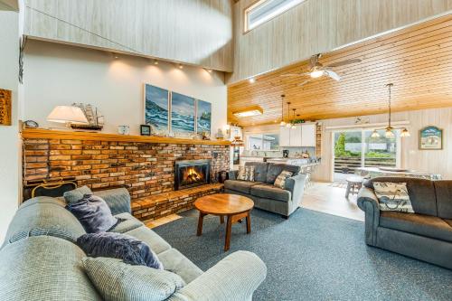 a living room with two couches and a fireplace at Beachtown Bliss in Rockaway Beach