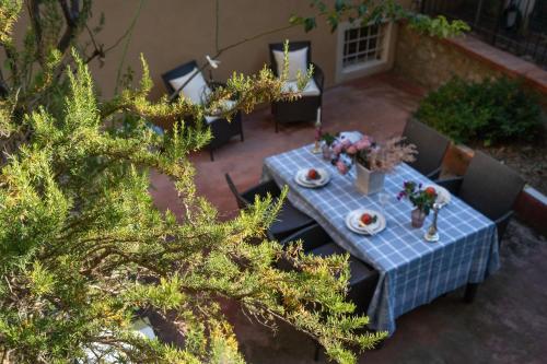 a table with a blue table cloth on a patio at Casa Collodi Castello in Collodi