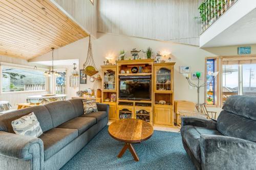 a living room with a couch and a table at Beachtown Bliss in Rockaway Beach