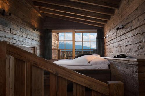 a bedroom with a bed and a window in it at Hotel Etrier in Crans-Montana