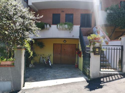 une maison avec un vélo garé devant elle dans l'établissement Porto Recanati Apartament, à Porto Recanati