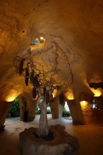 a sculpture of a tree in a cave at VC@Suanpaak Boutique Hotel & Service Apartment in Chiang Mai
