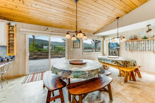 a dining room with a table and chairs and a window at Beachtown Bliss in Rockaway Beach