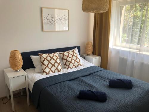 a bedroom with a bed with two pillows on it at Przystań w Pucku in Puck