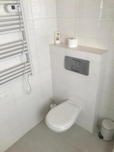 a white bathroom with a white toilet in it at Domek do wynajęcia SkoSki in Jaworzynka