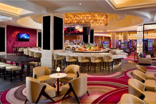 a restaurant with tables and chairs and a bar at Seminole Hard Rock Hotel and Casino Tampa in Tampa