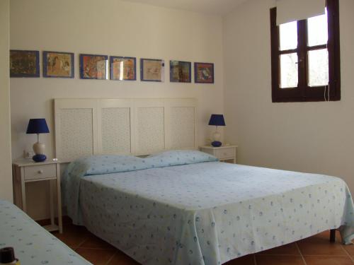 a bedroom with a bed and two tables and a window at Villa Franca in Pula