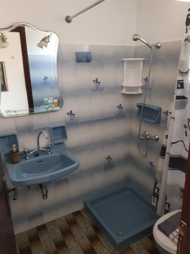 a bathroom with a blue sink and a toilet at Filippos Apartments "Room 6" in Spartià