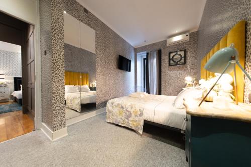a hotel room with a bed and a mirror at Bliss Lisbon Apartments - Avenidas in Lisbon