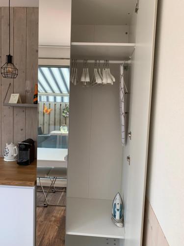 a kitchen with white walls and a white cabinet at B&B Diemerplein in Amsterdam