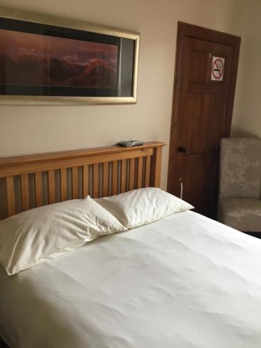 
a bedroom with a bed and a dresser at Bed and Breakfast at 4 in Thurso
