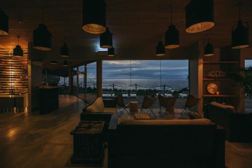 a living room with a view of the ocean at Santa Barbara Eco-Beach Resort in Ribeira Grande
