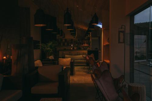 a living room with a couch and chairs at Santa Barbara Eco-Beach Resort in Ribeira Grande