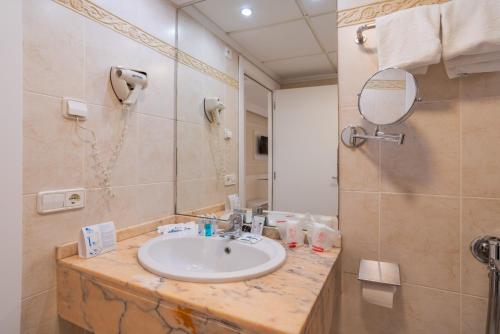 
a bathroom with a sink and a mirror at Gran Hotel Peñiscola in Peniscola
