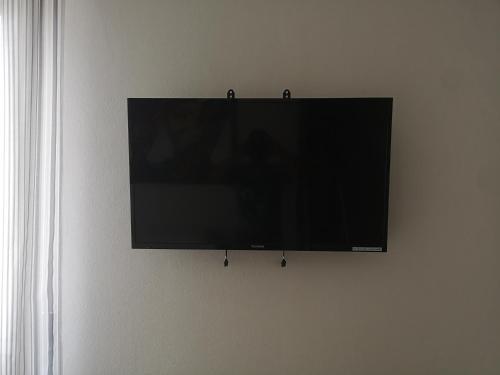 a flat screen tv hanging on a wall at SMART Rooms Pistoia in Pistoia
