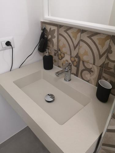 a white sink in a kitchen with at SMART Rooms Pistoia in Pistoia