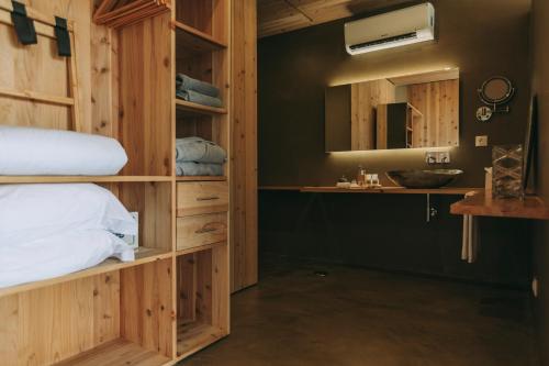 a bathroom with a bed and a sink at Santa Barbara Eco-Beach Resort in Ribeira Grande