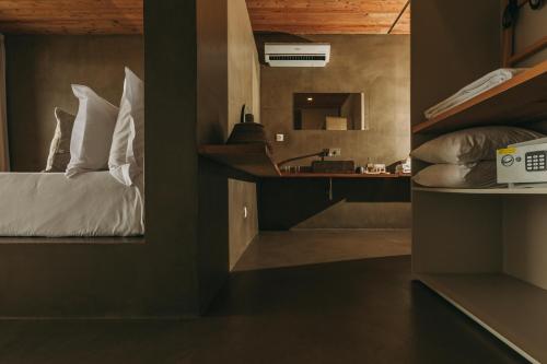 a small room with a bed and a desk at Santa Barbara Eco-Beach Resort in Ribeira Grande