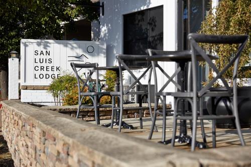 a group of chairs sitting in front of a building at San Luis Creek Lodge in San Luis Obispo