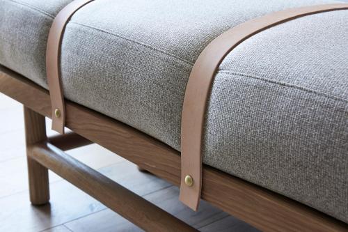a close up of a couch on a wooden stool at San Luis Creek Lodge in San Luis Obispo