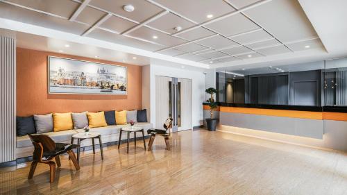 a living room with a couch and two tables at Season Place in Bangkok