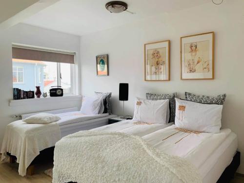 a bedroom with two beds and a window at Skólavörðustígur Apartments in Reykjavík