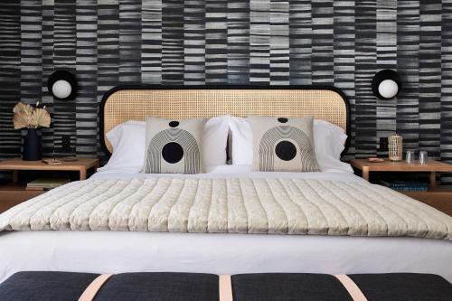 a bedroom with a large bed with a black wall at San Luis Creek Lodge in San Luis Obispo