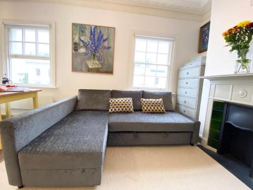 a living room with a couch and a fireplace at Stylish Apartments in Pimlico & Westminster in London