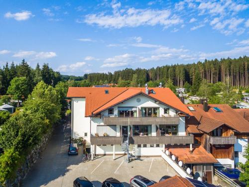 an aerial view of a house with an orange roof at Allgäu-Hotel-Elbsee in Aitrang