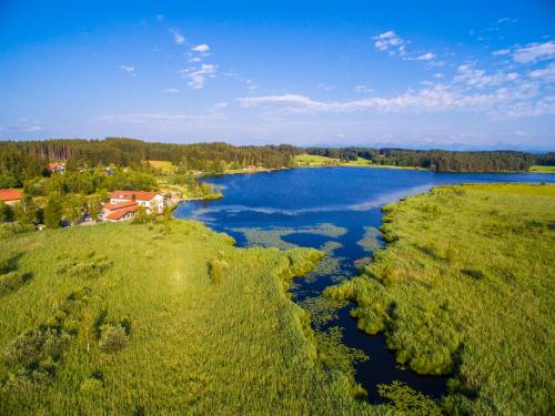 an aerial view of a river in a field at Allgäu-Hotel-Elbsee in Aitrang
