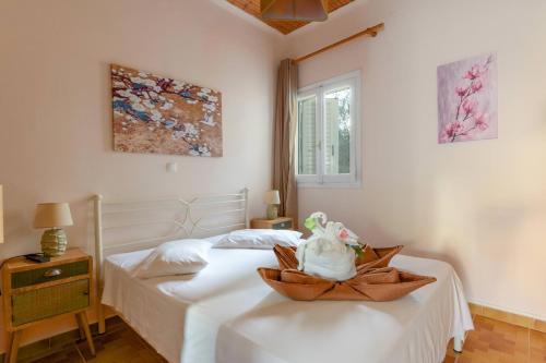a bedroom with two beds and a basket on a table at Zoumpouli Village in Spartià