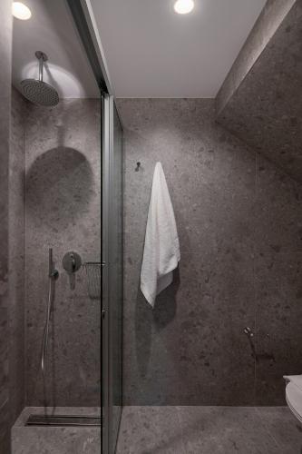 a bathroom with a shower with a glass door at Camere Maritima in Chania Town
